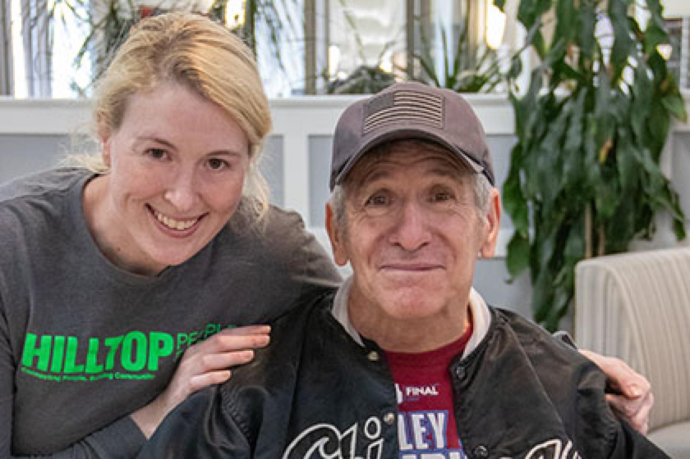 Staff and resident smiling at camera